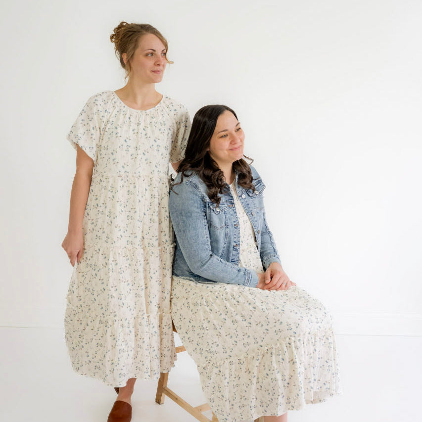 Modest women’s sweaters, denim skirts, and floral dresses on white hangers