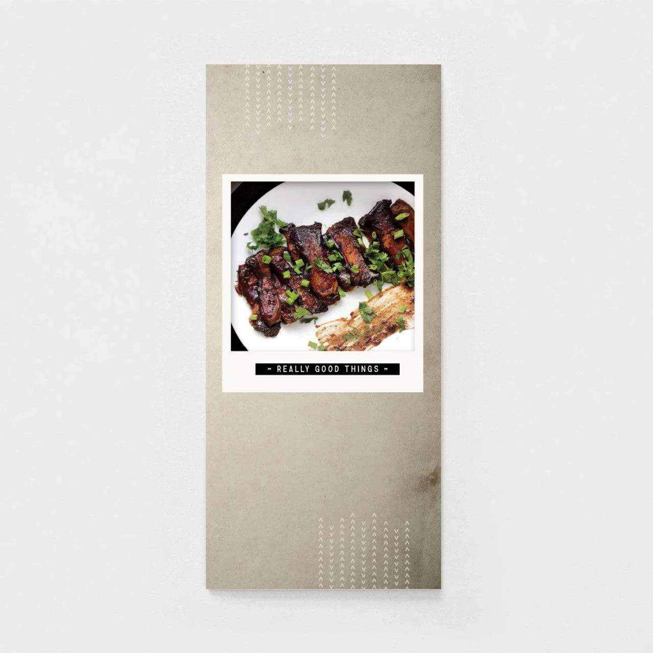 Masculine birthday greeting card with grilled ribs and herbs on a minimalist, neutral background.