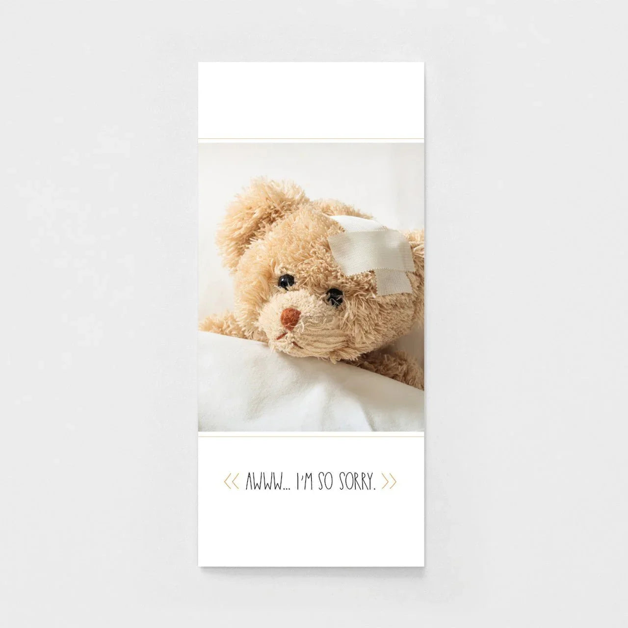 Get well soon greeting card with a cute teddy bear in bed and a bandage on its head