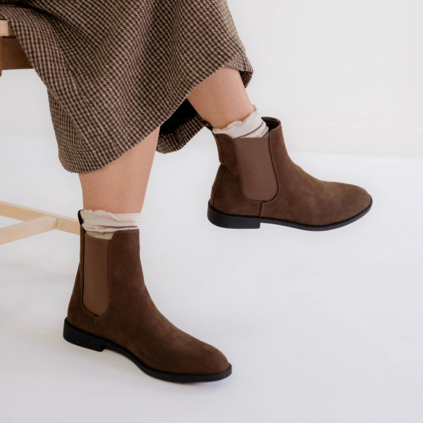 Brown ankle boots with beige socks and a modest houndstooth midi skirt for women