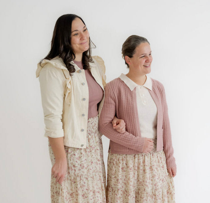 Two women in modest floral skirts and sweaters, smiling in Salt and Honey boutique style