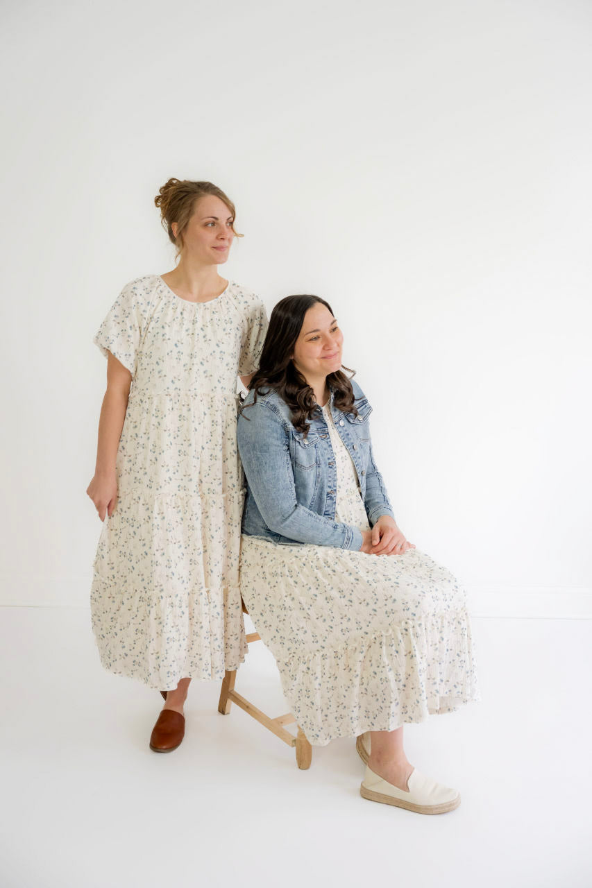 Modest women’s sweaters, denim skirts, and floral dresses on white hangers
