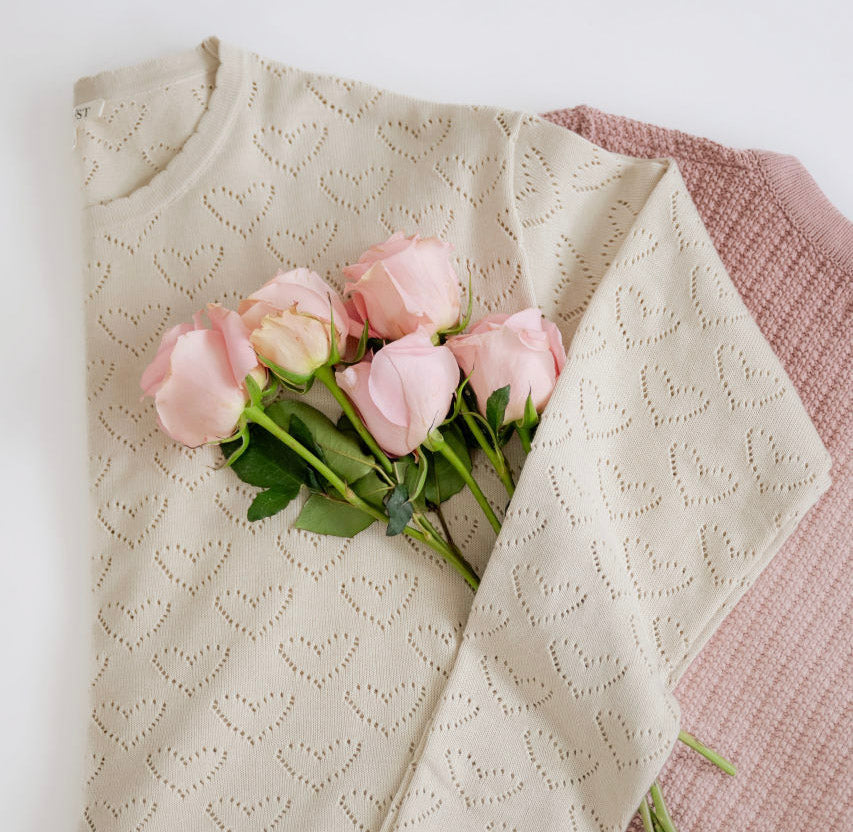 Cream modest heart-pattern sweater on pink fabric with pink roses, Salt and Honey boutique