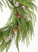 Decorative greenery with gold ornaments and pinecones on a white background