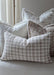 Decorative pillows on a sofa with floral and plaid patterns