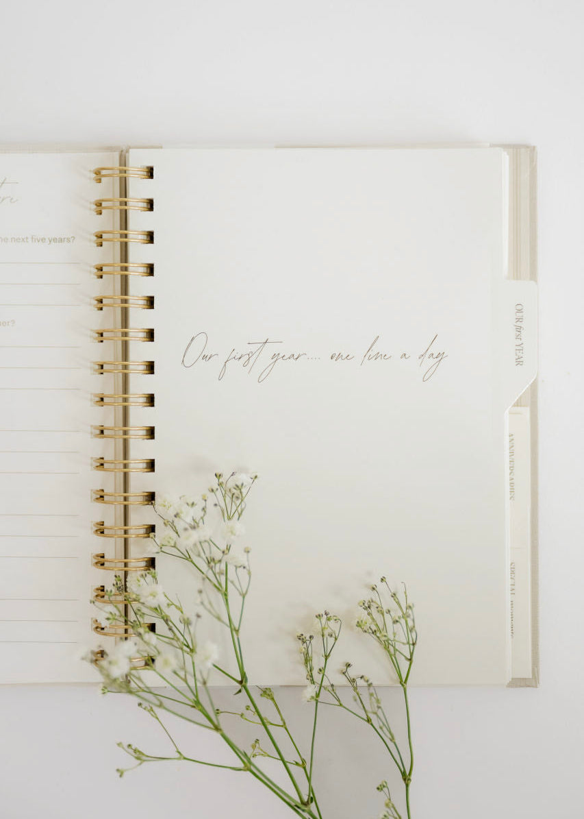 Open notebook with floral branch on a white background