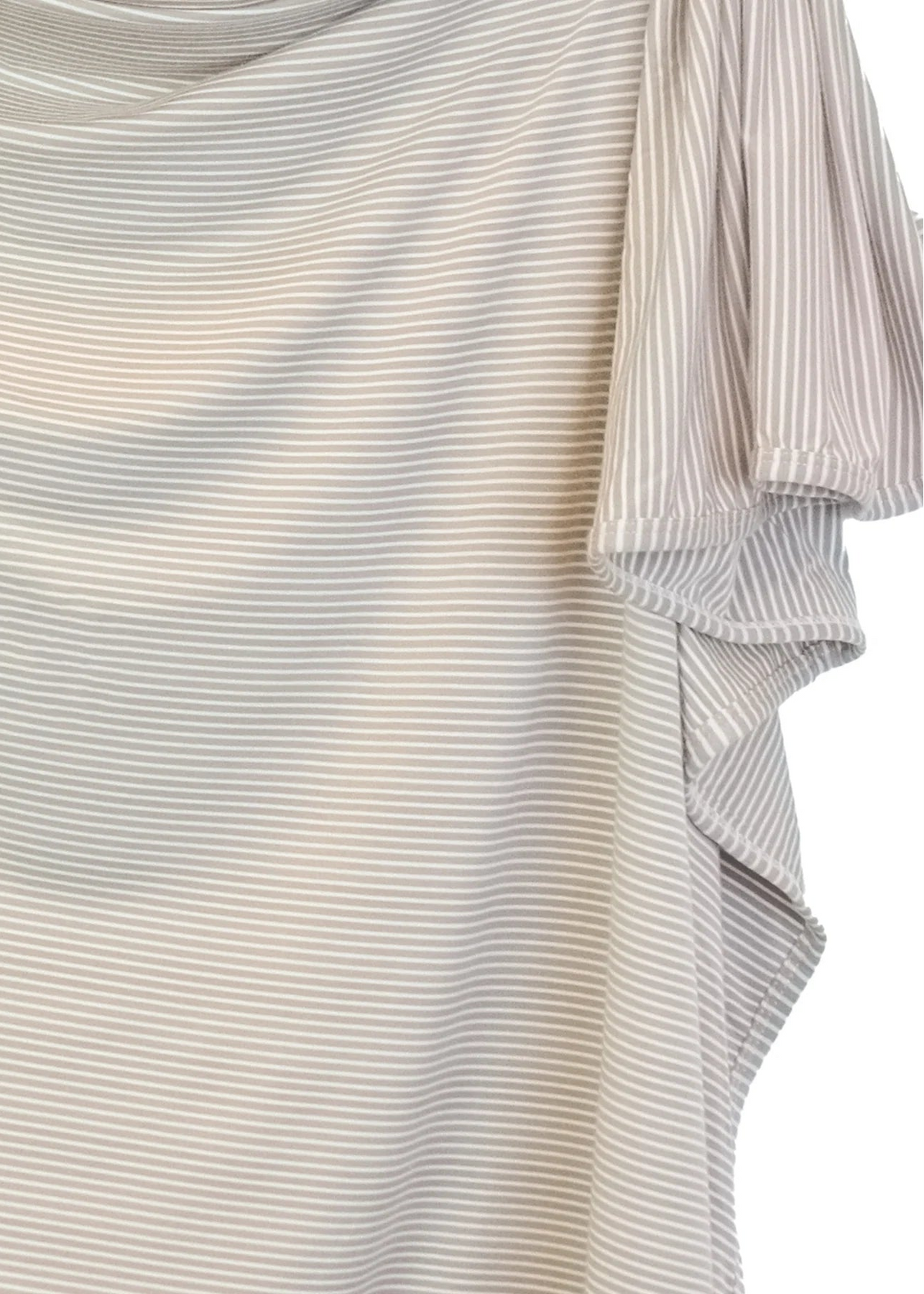 A close-up of a draped, short-sleeved top with fine horizontal stripes in beige and gray, featuring a ruffled side hem.
