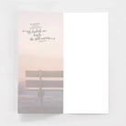 Inspirational blank greeting card with Psalm 23:2, bench, and serene misty background.