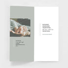 New baby greeting card with photo of adult hands holding baby feet and blessing message inside.