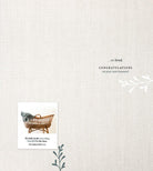 Minimalist baby congratulations card with basket, blanket, Ecclesiastes 3:11 verse, and leaf accents.